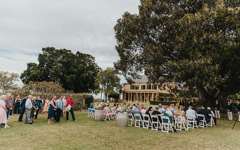 Wedding party gathers outdoors at Jimbour House