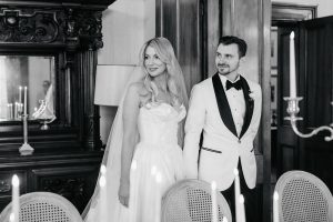 Bride and groom enter a candlelit dining room at Jimbour House for an intimate wedding reception, dressed in black tie attire with vintage-inspired styling.
