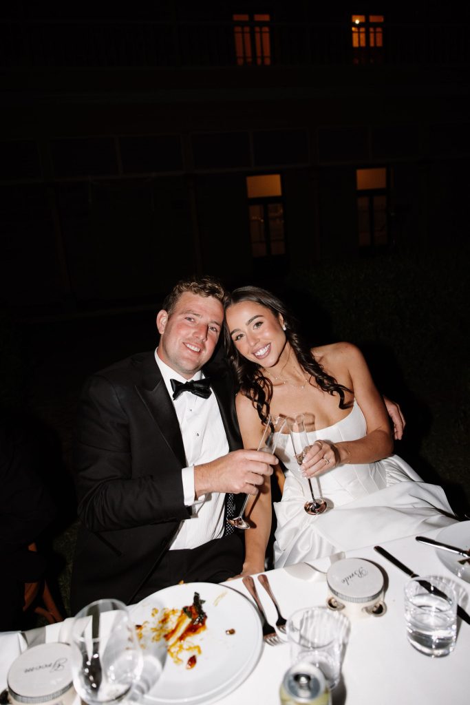 Bride and groom toasting with champagne at evening wedding reception at Jimbour House Queensland